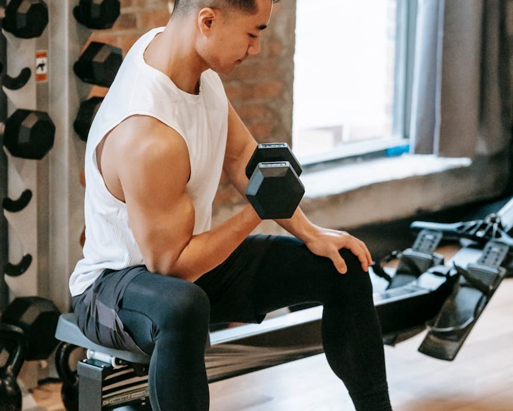 Man focusing on a rhythmic sequence of exercises in a gym.